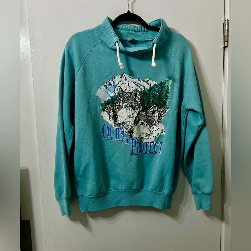 Vintage sweatshirt aqua with image of mountains and wild life tag worn out